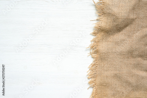Photos Sackcloth on a white kitchen wooden table background with copy space