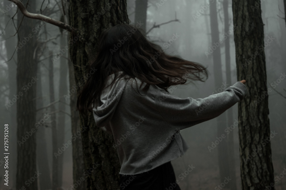 Young woman in the dark forest