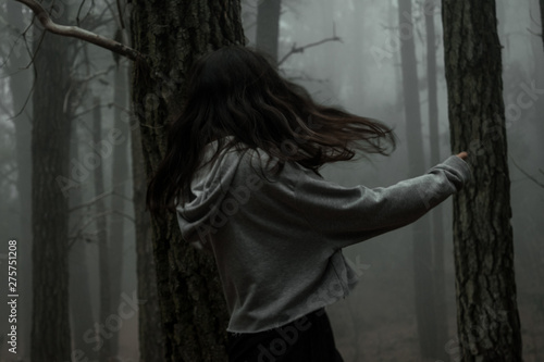 Young woman in the dark forest