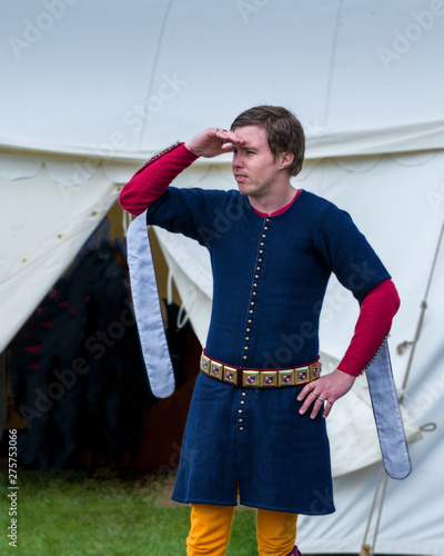 A medival squire surveys the camp.
