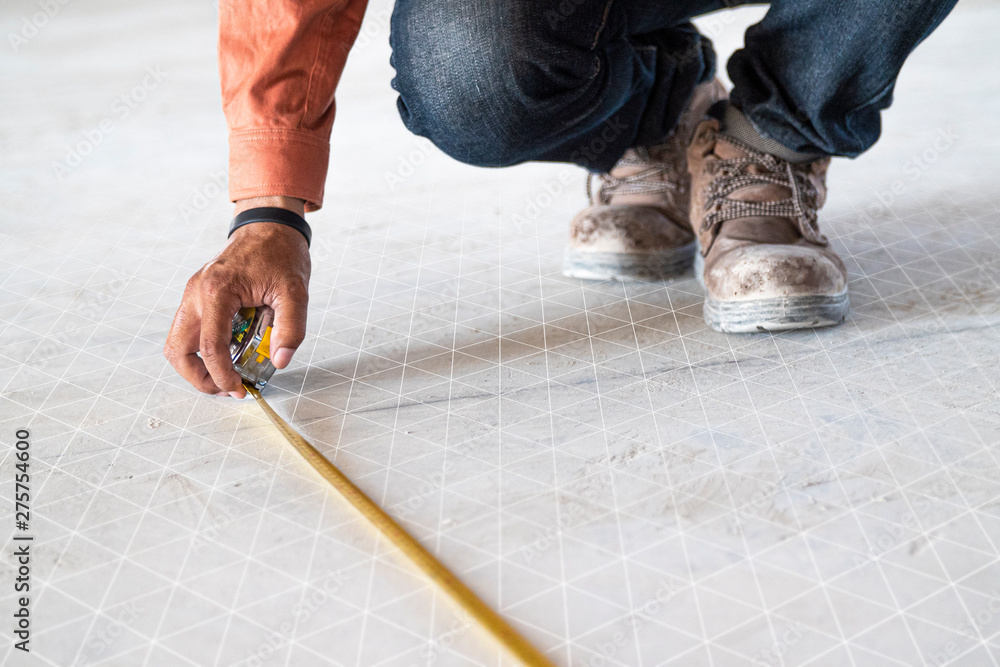 Measuring the distance in the construction and interior decoration of the building by skilled technicians. There are graphics, grid lines to display. Measuring the distance in the construction and interior decoration of the building by skilled technicians. There are graphics, grid lines to display.
