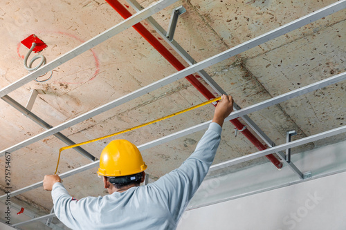 Measuring distance and planning the armstrong ceiling installation with acoustic panels With professional technicians photo