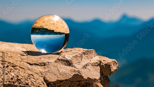 Crystal ball alpine landscape shot on a rock at the Herzogstand summit, Walchensee, Bavaria, Germany
