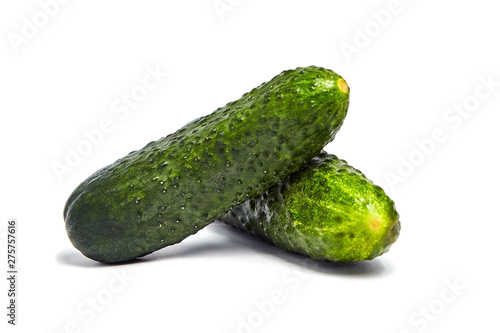 Two green fresh gherkins isolated on white background