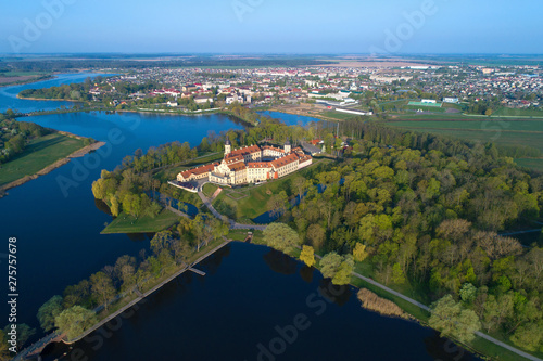 Old Nesvizh Castle against the background of the cityscape on a May morning (aerial photography). Belarus