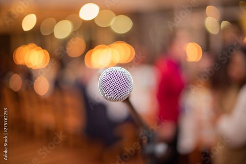 Microphone on stage with blurred lights in the background