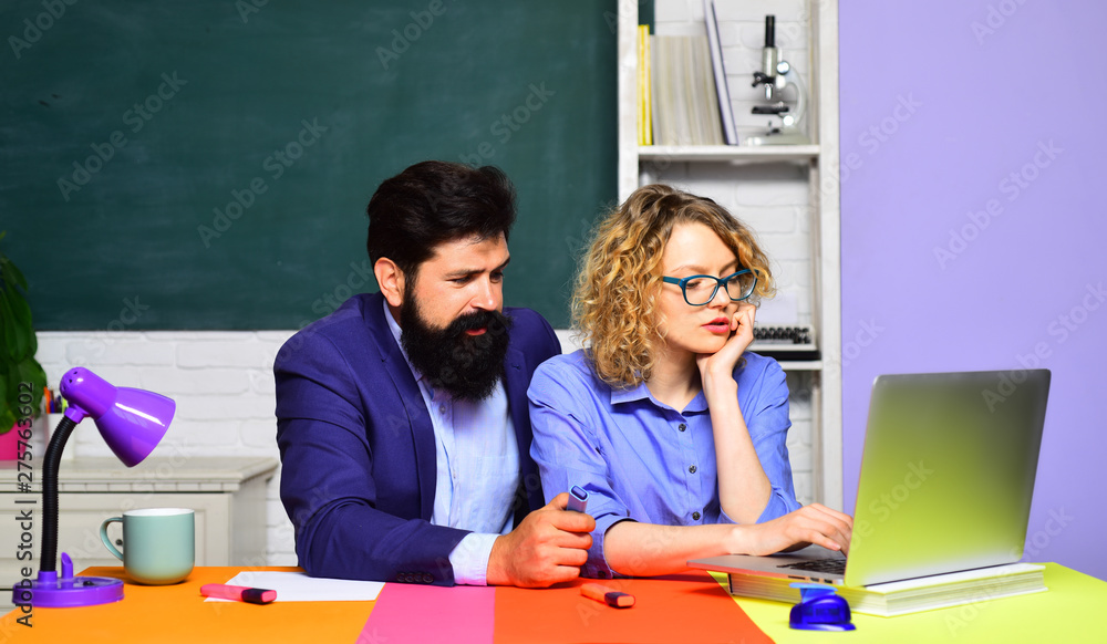 University students at college. Girl student with bearded teacher in auditorium. Learning, education concept. Funny young teacher with young student in classroom. Serious teachers couple in classroom. University students at college. Girl student with bearded teacher in auditorium. Learning, education concept. Funny young teacher with young student in classroom. Serious teachers couple in classroom.