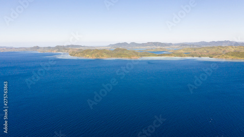 Seascape with islands. Blue sea and large islands. Big island with woodland. Philippines, El Nido