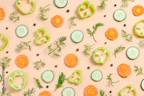 Fototapeta Naklejka Na Ścianę i Meble -  Salad ingredients layout. Food pattern with cherry tomatoes, carrot, cucumbers, radish, greens, pepper and spices