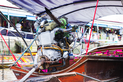 Engine on a longtail boat of amphawa floating market is the tourist most popular in Samut Songkhram, thailand.