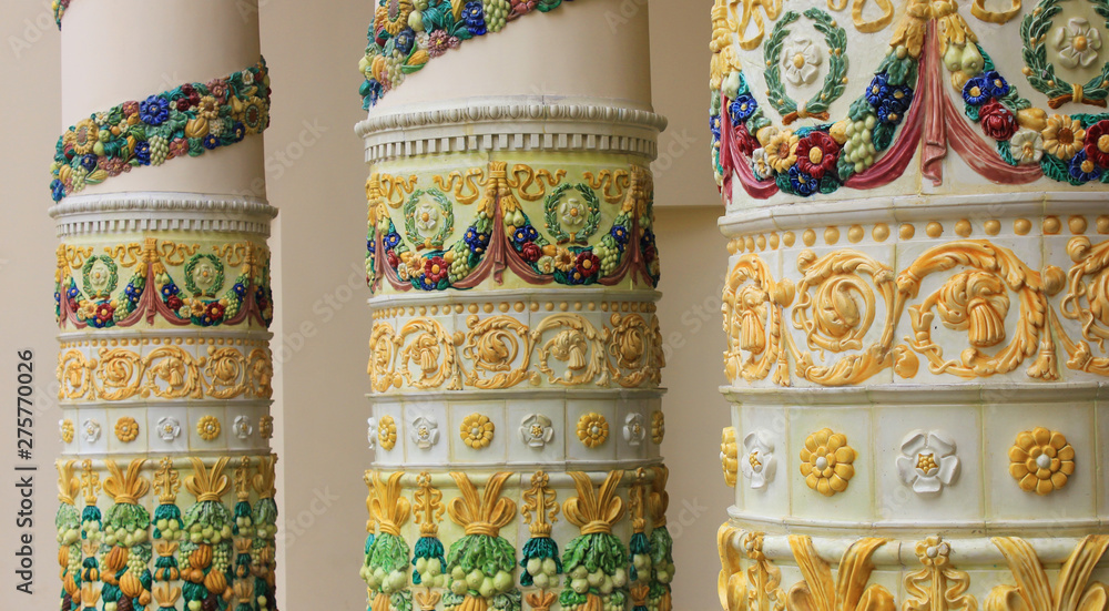 Colorful columns with ceramic ornamental design on old historical building architecture 