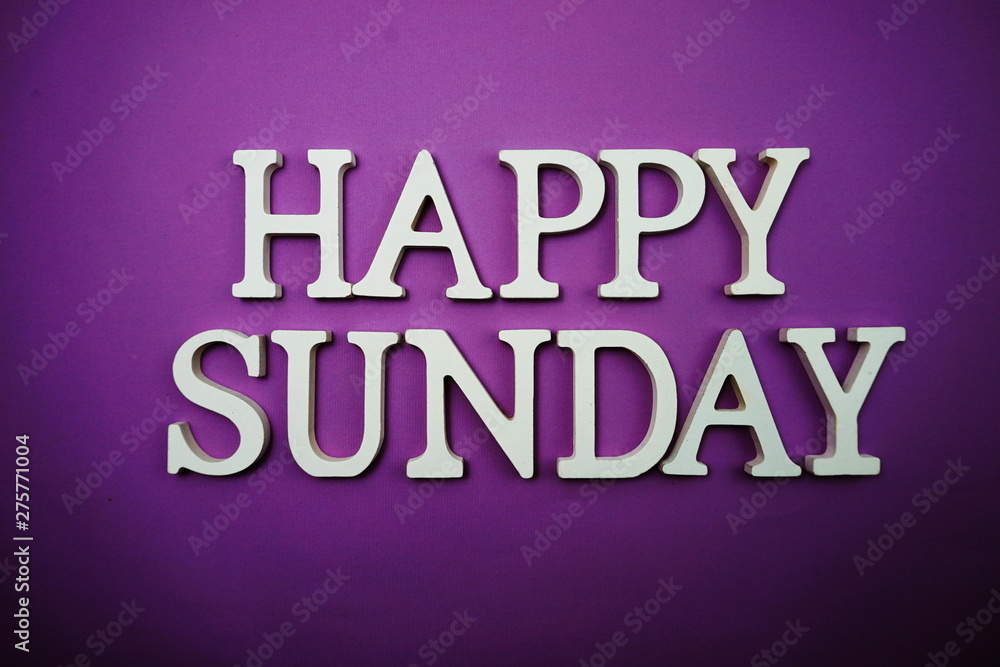 Happy Sunday wooden letter alphabet on purple background