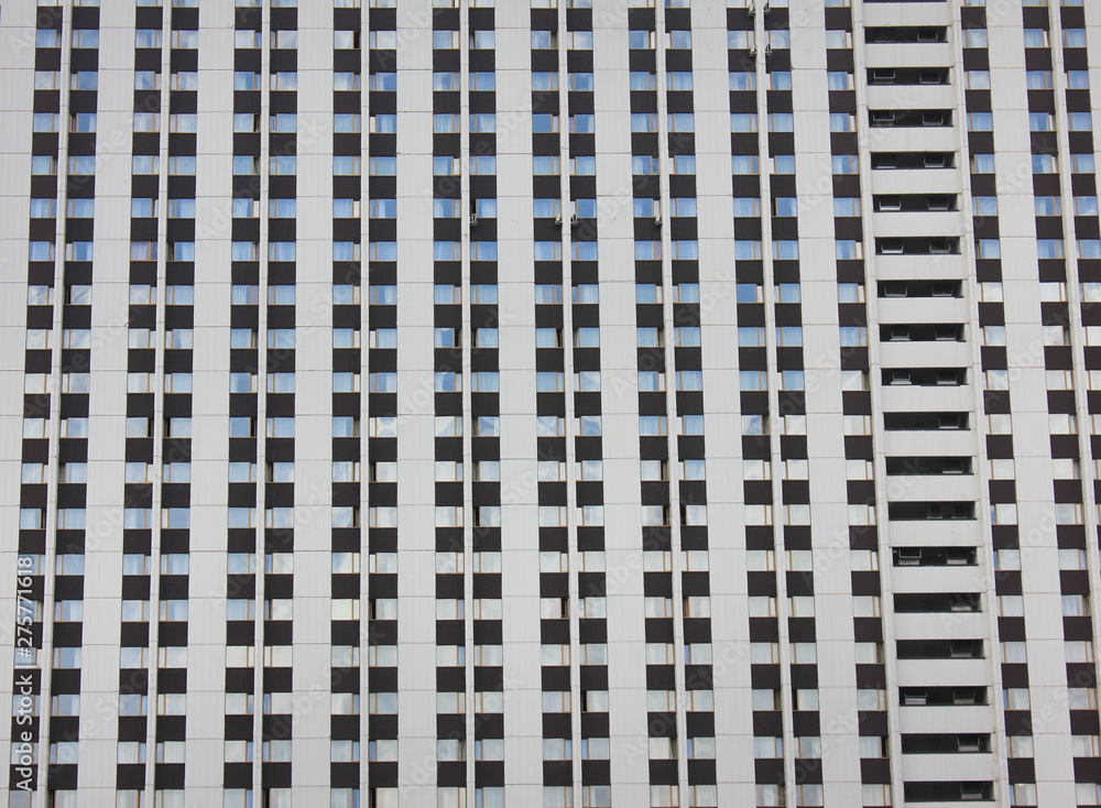Windows pattern on white building facade. House front with windows in row, simple architecture close up view Windows pattern on white building facade. House front with windows in row, simple architecture close up view