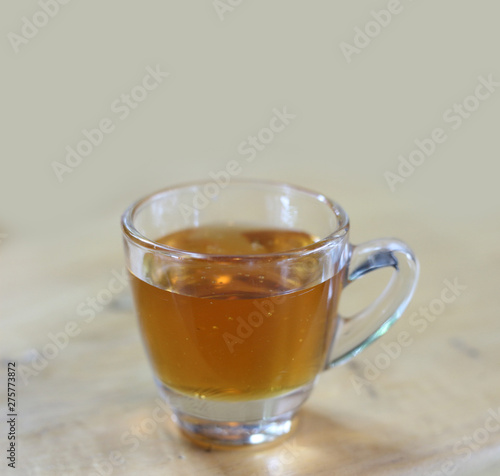 honey in glass on wood background