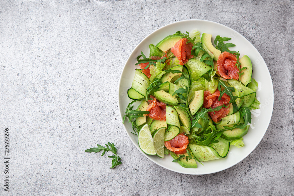 avocado, smoked salmon and cucumber salad on white plate avocado, smoked salmon and cucumber salad on white plate