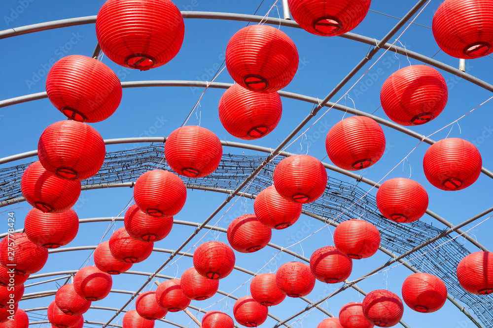 Red paper lantern against blue sky.