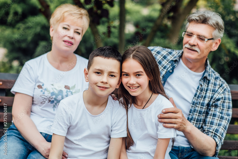 Fototapeta premium Grandparents and grandchildren enjoying day together on nature.