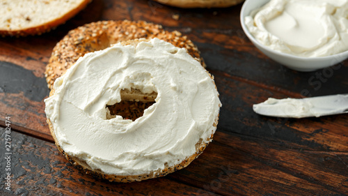 Bagels sandwich with cream cheese on wooden table