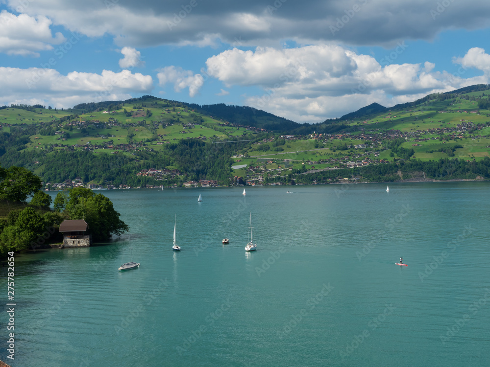 Spiez, Switzerland - May 30th 2019: People are sailing sailboat at Thun Lake, Spiez Switzerland