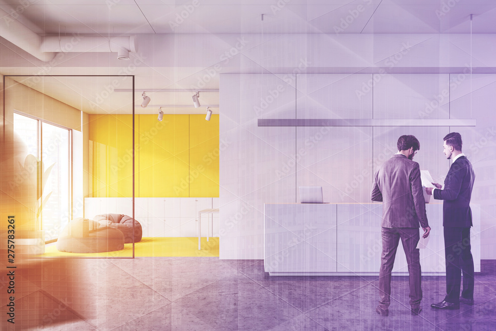 Men in white and yellow office with reception Men in white and yellow office with reception