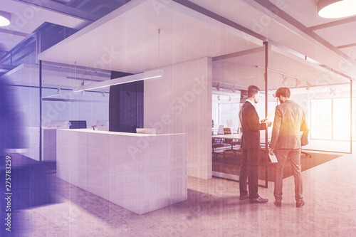 Businessmen near office reception desk