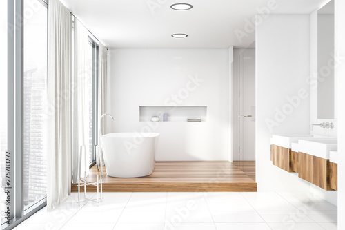 White bathroom with double sink and tub