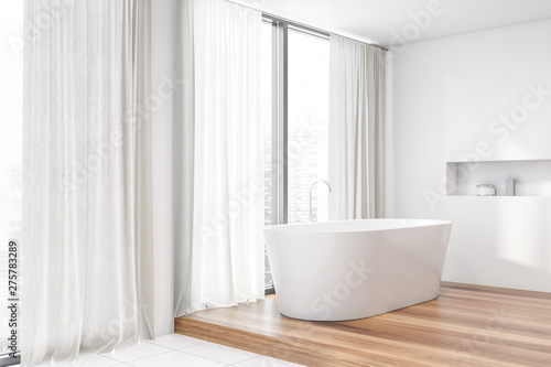 White bathroom corner  tub and window