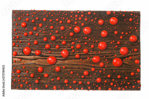 Beautiful colorful water droplets on a wooden frame. Red drops of paint.