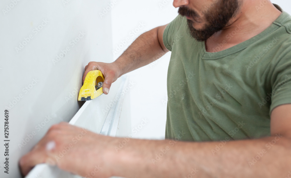 Worker building plasterboard wall. Worker building plasterboard wall.