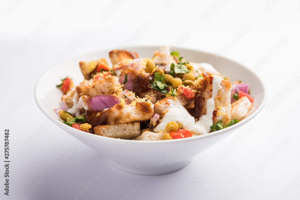 Bread chaat/chat is a yummy starter/appetizer from India, served in a bowl garnished with tomato, sev and coriander and masala. selective focus Bread chaat/chat is a yummy starter/appetizer from India, served in a bowl garnished with tomato, sev and coriander and masala. selective focus