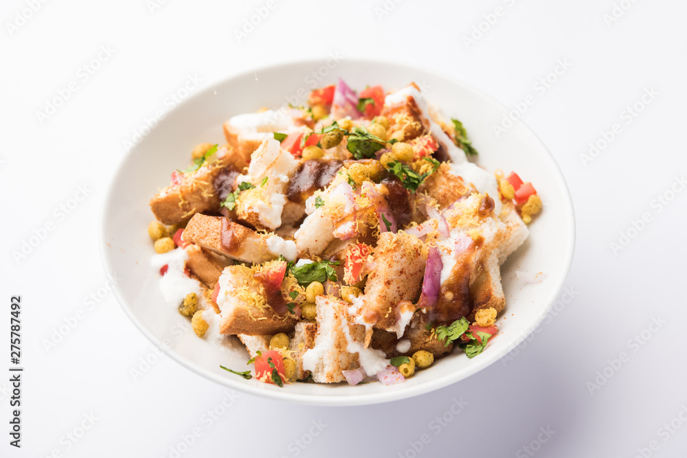 Bread chaat/chat is a yummy starter/appetizer from India, served in a bowl garnished with tomato, sev and coriander and masala. selective focus Bread chaat/chat is a yummy starter/appetizer from India, served in a bowl garnished with tomato, sev and coriander and masala. selective focus