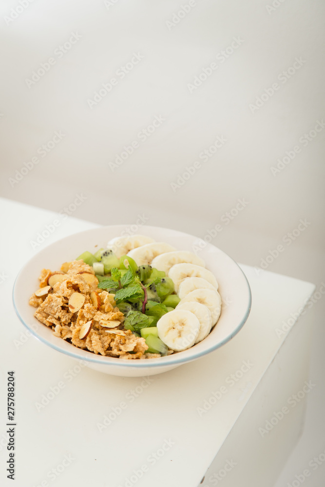Healthy breakfast with high fibre bran flakes, kiwi and banana Healthy breakfast with high fibre bran flakes, kiwi and banana