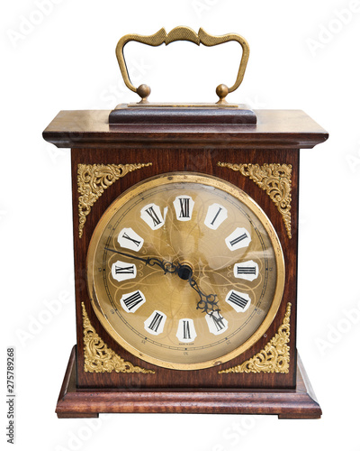 Vintage beautiful clock with a wooden case and gold jewelry isolated on white background