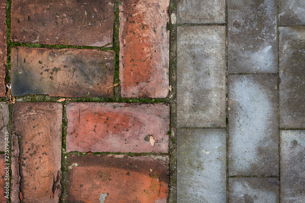 Old and new - red bricks and gray cement blocks flooring Old and new - red bricks and gray cement blocks flooring