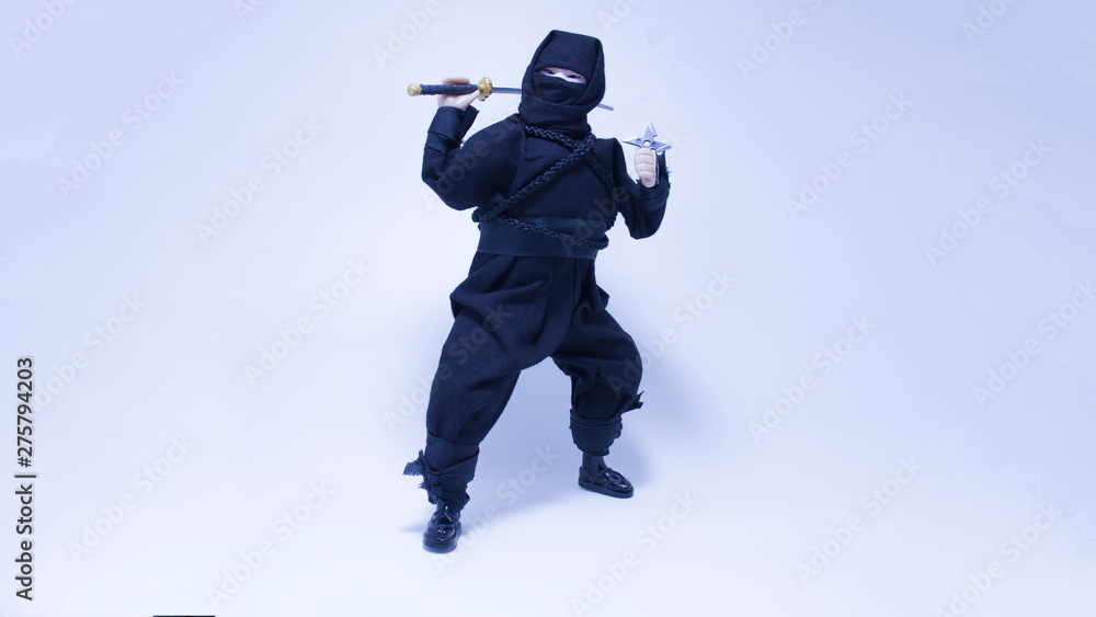 Ninja in black clothes with sword and shuriken Ninja in black clothes with sword and shuriken