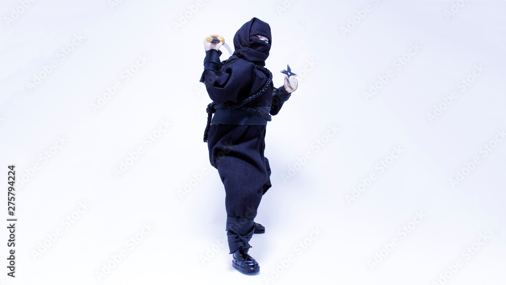 Ninja in black clothes with sword and shuriken Ninja in black clothes with sword and shuriken