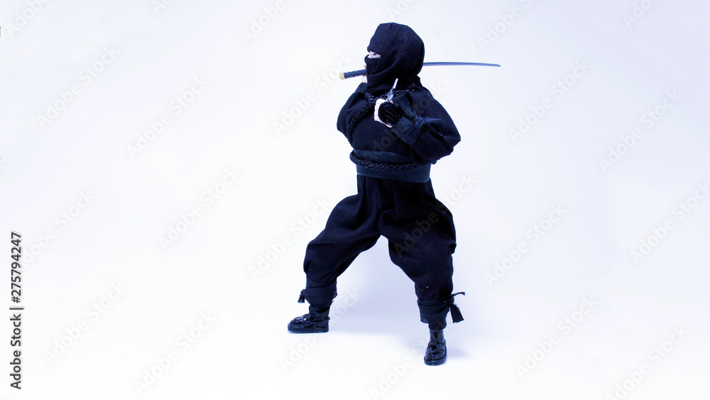 Ninja in black clothes with sword and shuriken Ninja in black clothes with sword and shuriken