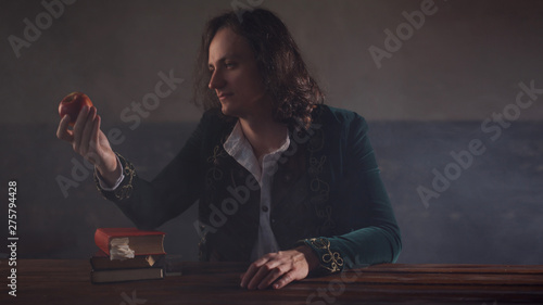 History of science, concept. Isaac Newton with Apple in hand photo