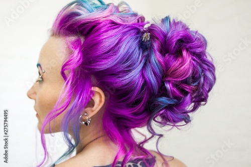 Delightfully bright colored hair, multi-colored coloring on long hair. An elegant high hairstyle