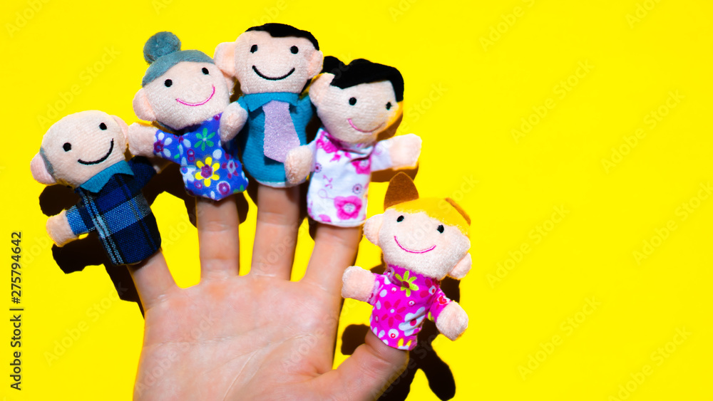 Puppet theater. Hand wearing finger family members puppets: mum, dad, grandmother, grandfather, father, mom, daughter. generation concept.