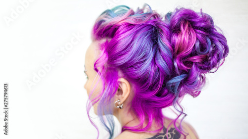 Wedding hairstyle of curls for a modern and unusual bride. Portrait of a young stylish woman with bright colored hair.