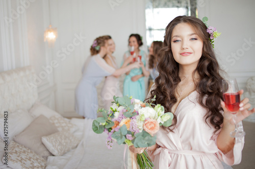Young beautiful brunette at a bachelorette party. A young woman with a bouquet of flowers,