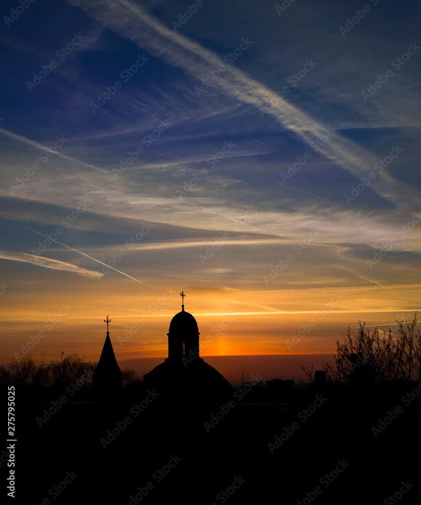 cloudscape with airplane trails at the sunset in Vilnius, Lithuania, Baltic states