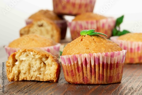 Vanilla cupcake, homemade pastry on wooden background