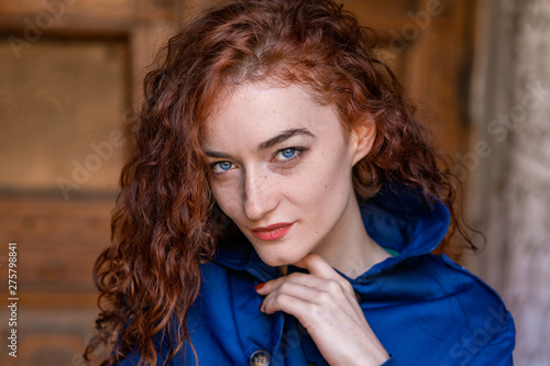 portrait of cute red-haired girl , wavy hair and beautiful eyes photo