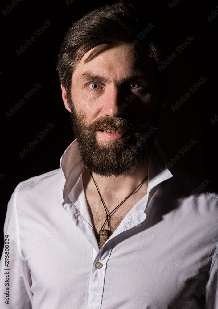 Obraz premium Portrait handsome bearded man, sexy guy on a dark background