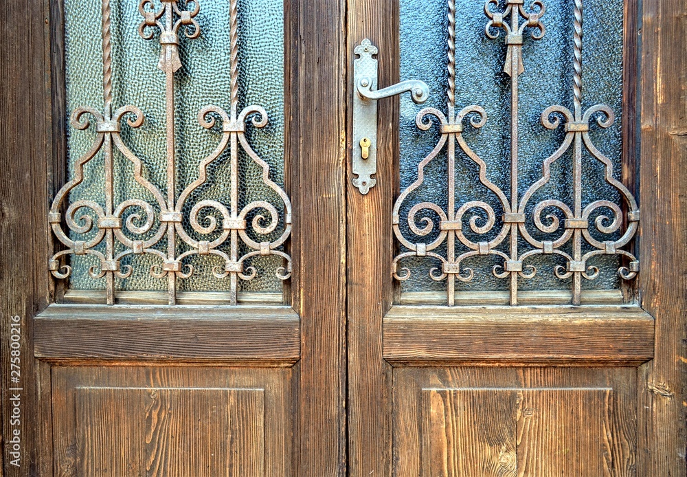 old wooden door with wrought iron grille old wooden door with wrought iron grille
