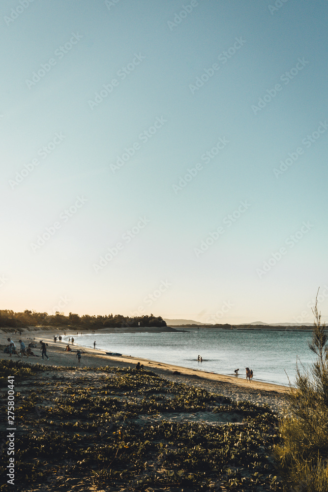 Yamba, New South Wales, Australia - October 1st, 2018: Late afternoon sun on Hickey Island beach. Yamba, New South Wales, Australia - October 1st, 2018: Late afternoon sun on Hickey Island beach.