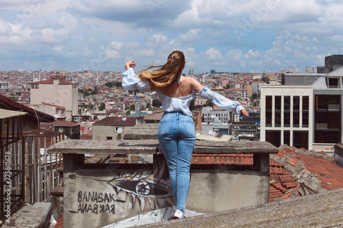 Woman in rooftop with a view to Istanbul sity center. Travel alone, love istanbul consept. © Tetiana