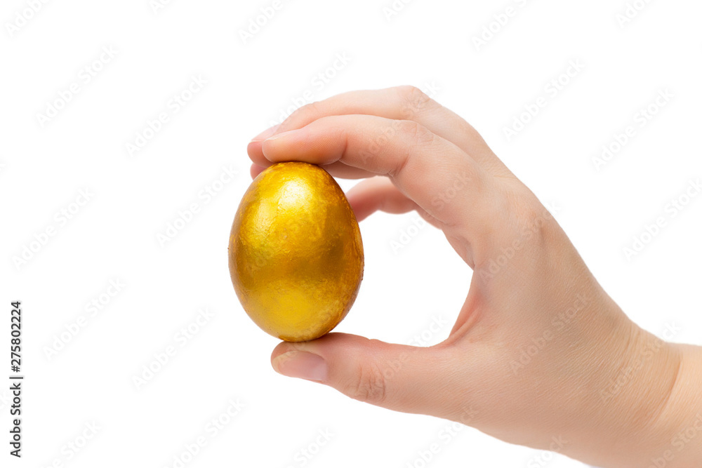 Golden egg in hand on a white background, isolate. Concept of wealth, winnings, good luck Golden egg in hand on a white background, isolate. Concept of wealth, winnings, good luck